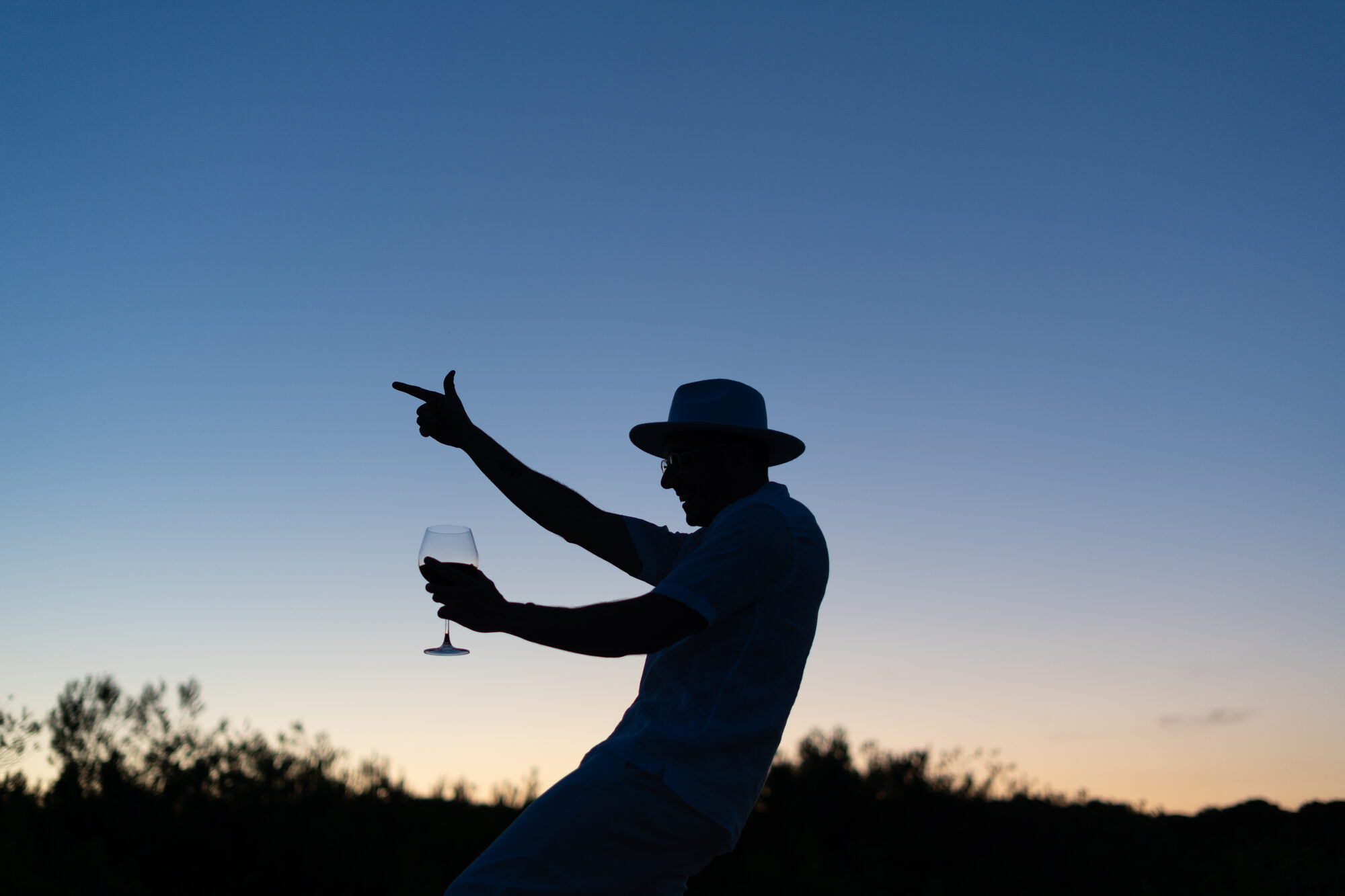 Guillaume at dusk, glass raised