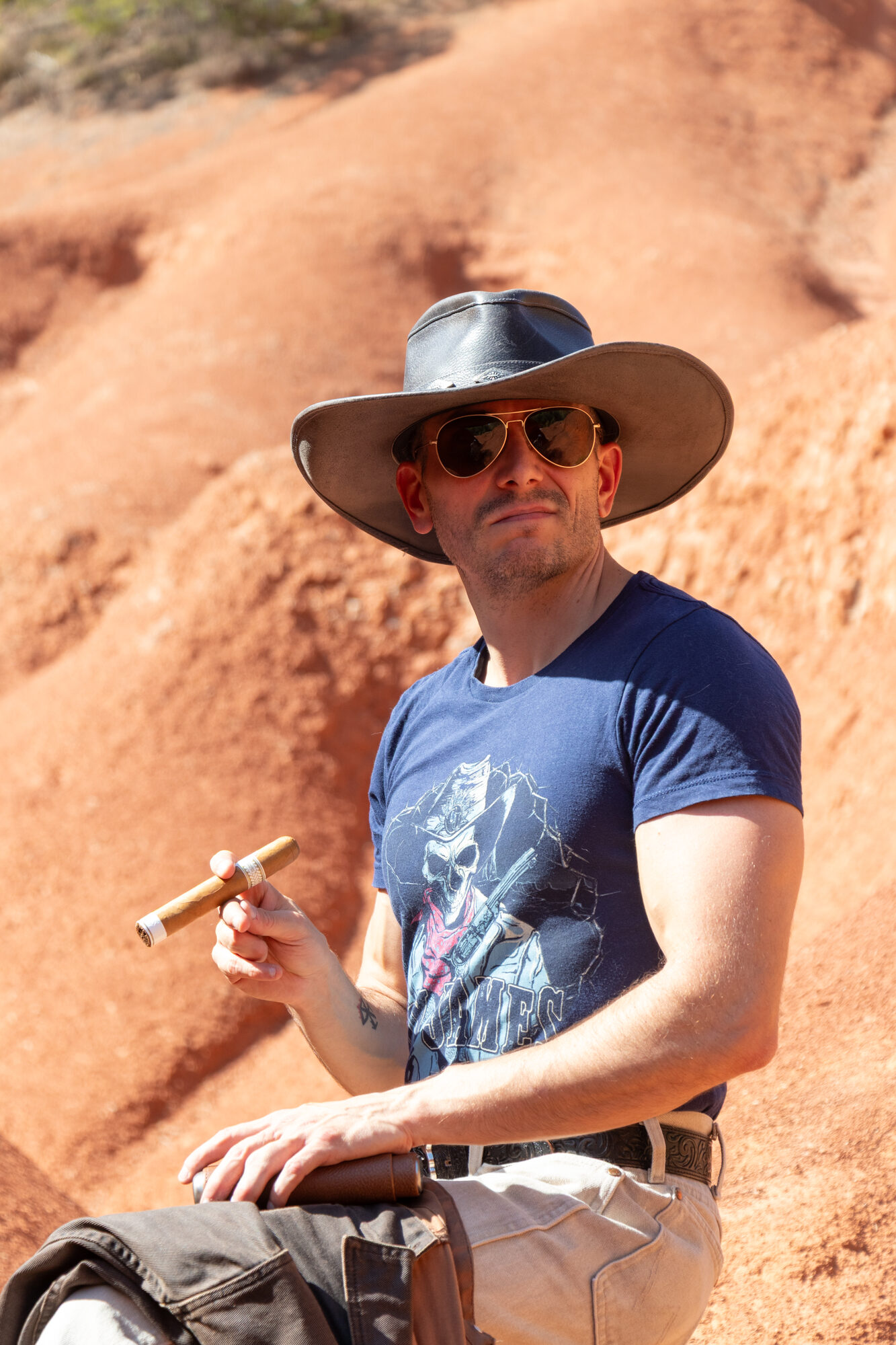 Guillaume with a cigar on red rock